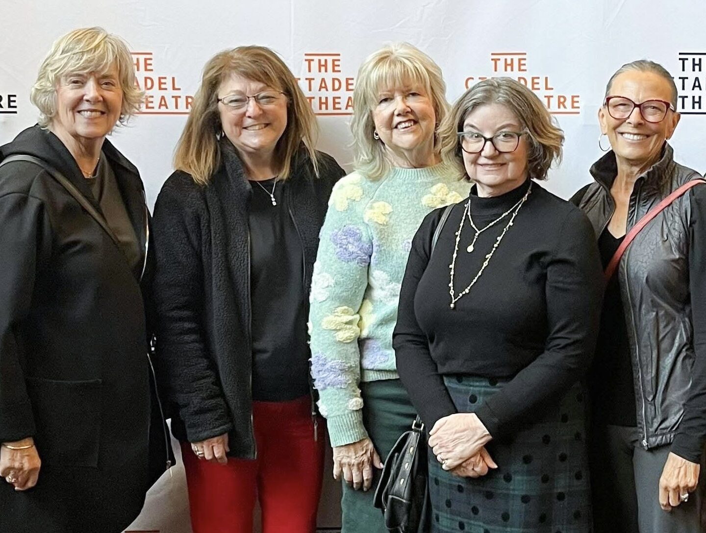 Edmonton Newcomers & Friends Club women standing together smiling at the Citadel Theatre.
